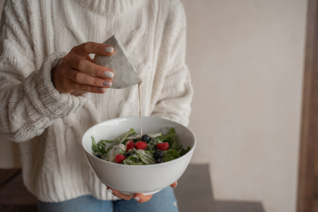 A person holding a bowl of food
Description automatically generated with low confidence